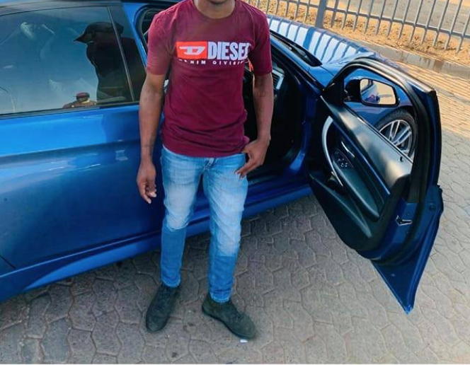 man poses with alleged stolen car