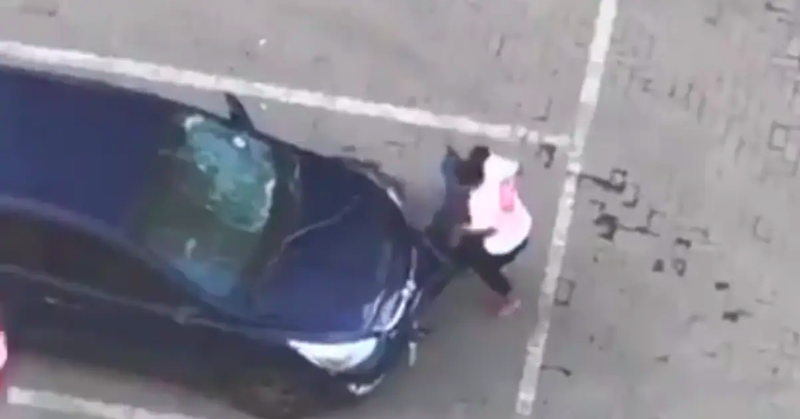 woman destroying car