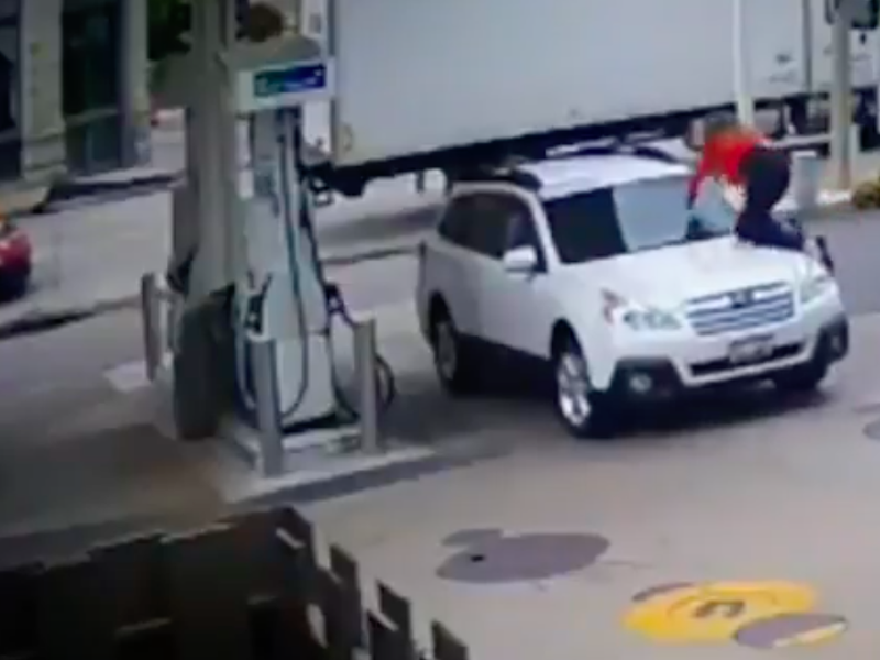 Woman jumps on her car at petrol station to stop hijacker
