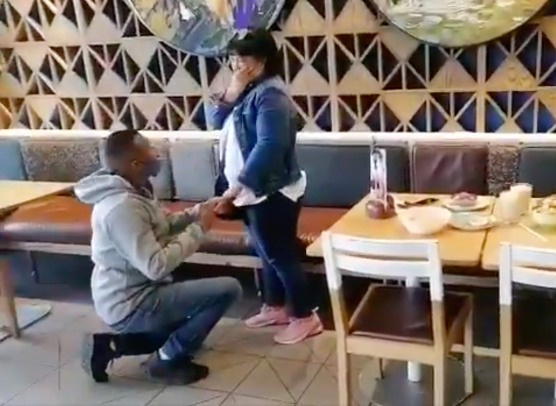 Couple getting engaged at Nandos