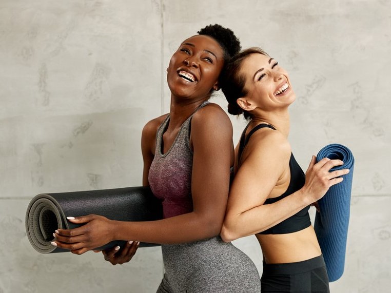 Two women working out with yoga mats