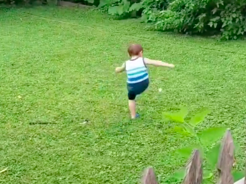 Toddler playing golf