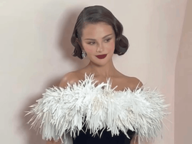 Selena Gomez wearing a strapless gown with a feather trim