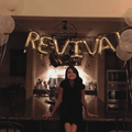 Selena Gomez sitting below gold letter balloons that read Revival
