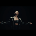 Selena Gomez wearing a black leather coat