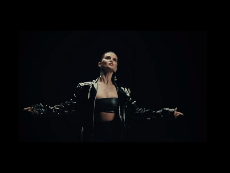 Selena Gomez wearing a black leather coat
