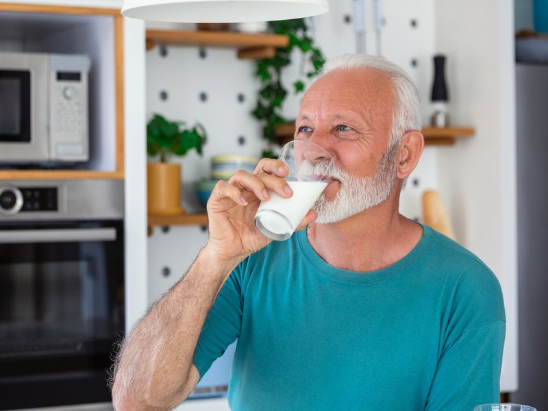 Senior man drinking a glass of milk