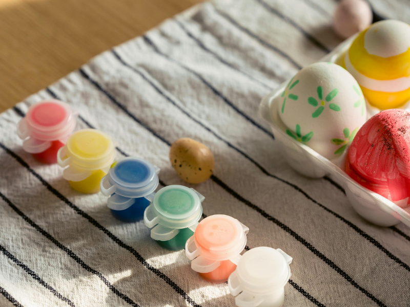 Set of paints with easter eggs on a tray
