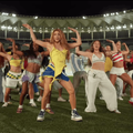 Shakira and dancers perform on a football pitch