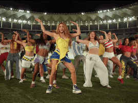 Shakira and dancers perform on a football pitch