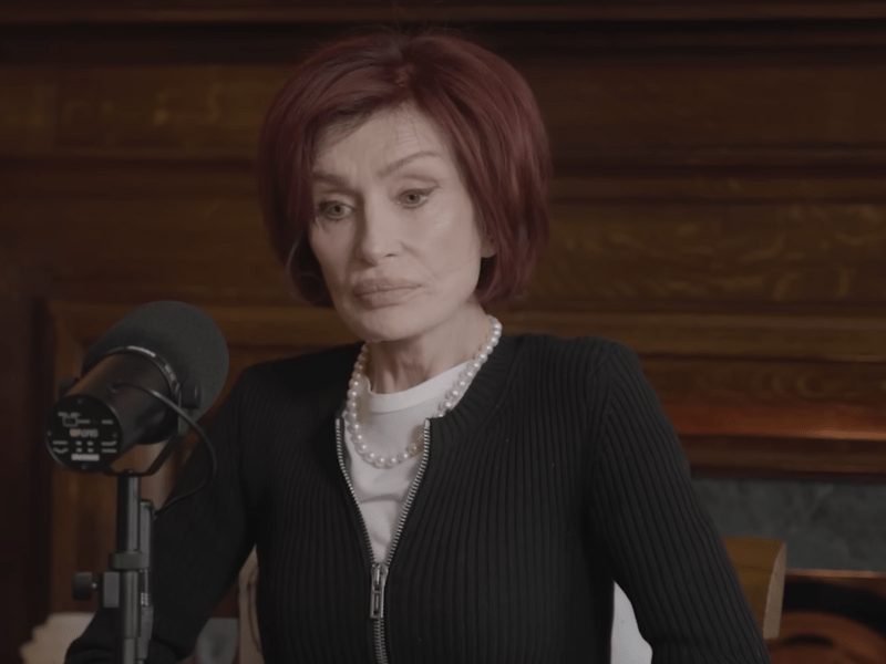 Sharon Osbourne sits in front of a mic