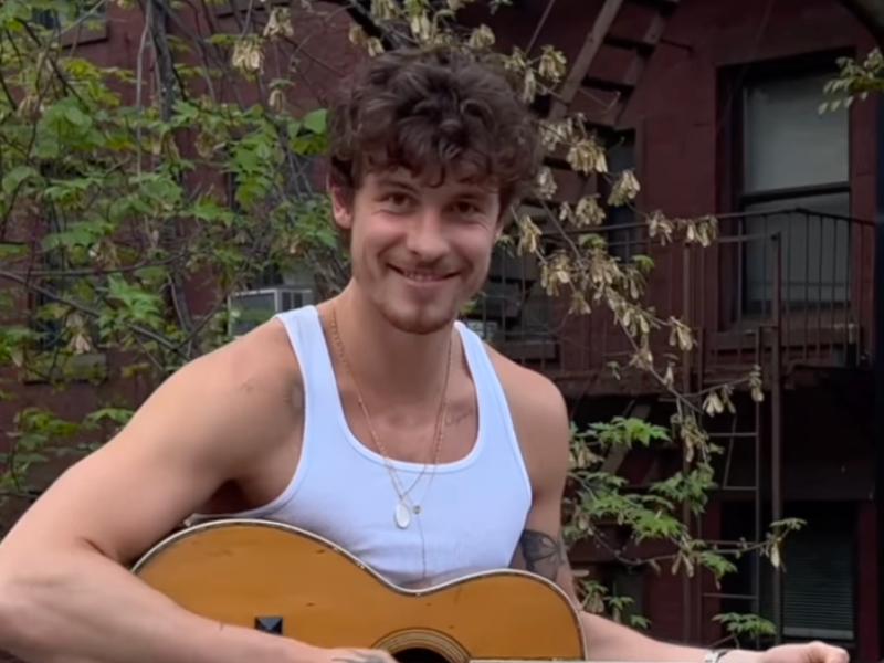 Shawn Mendes playing a guitar