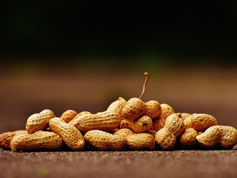 Shell peanuts lying on a wooden table top