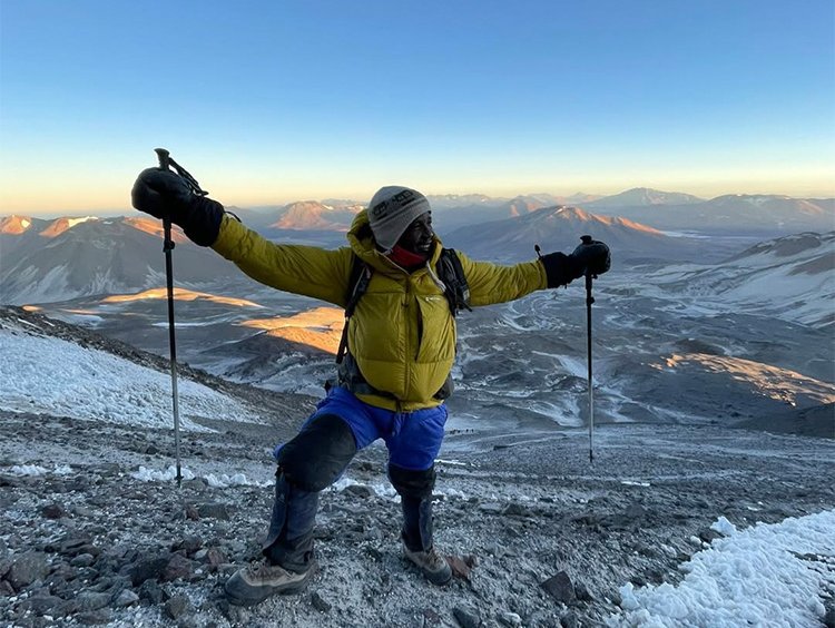 Sibusiso Vilane summitting a mountain