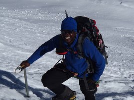 Sibusiso Vilane summitting a snowy mountain