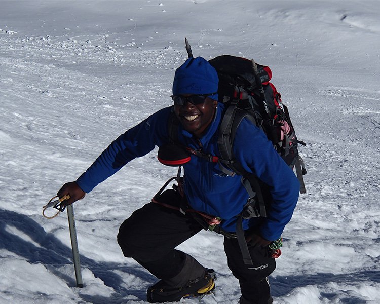 Sibusiso Vilane summitting a snowy mountain