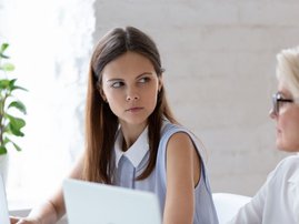 Woman side stares at colleague