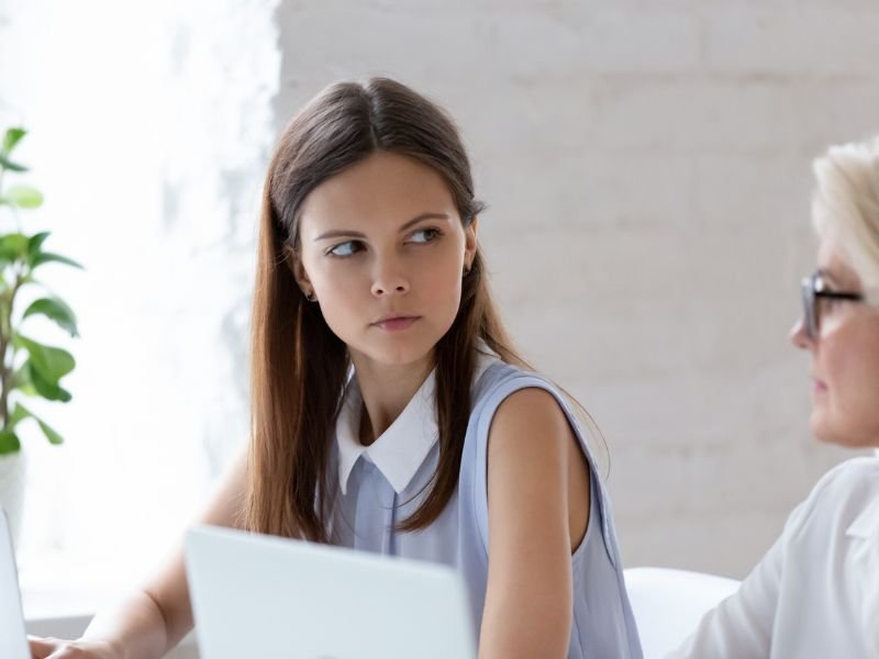Woman side stares at colleague
