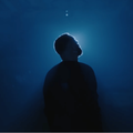 Silhouette of Sam Smith standing against a deep blue background