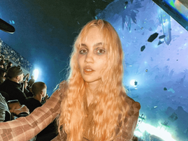Singer Grimes at a show featuring floating crystals