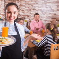 Waitress serving family at restaurant