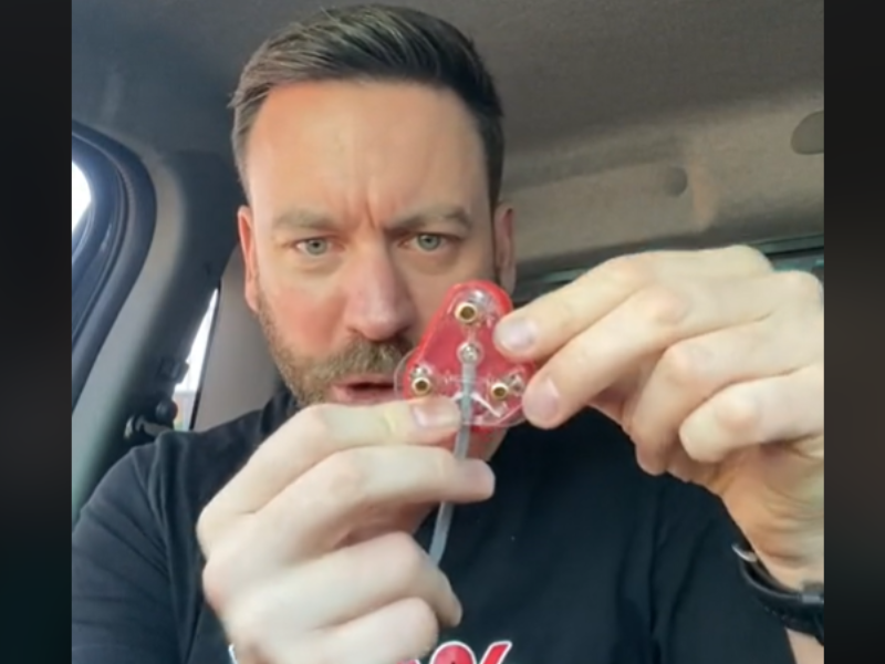 South African comedian Rory Petzer holds a three-pin plug