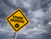 Storm warning sign over stormy sky