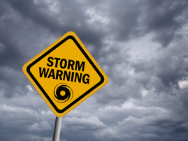 Storm warning sign over stormy sky