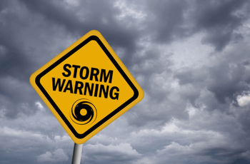 Storm warning sign over stormy sky