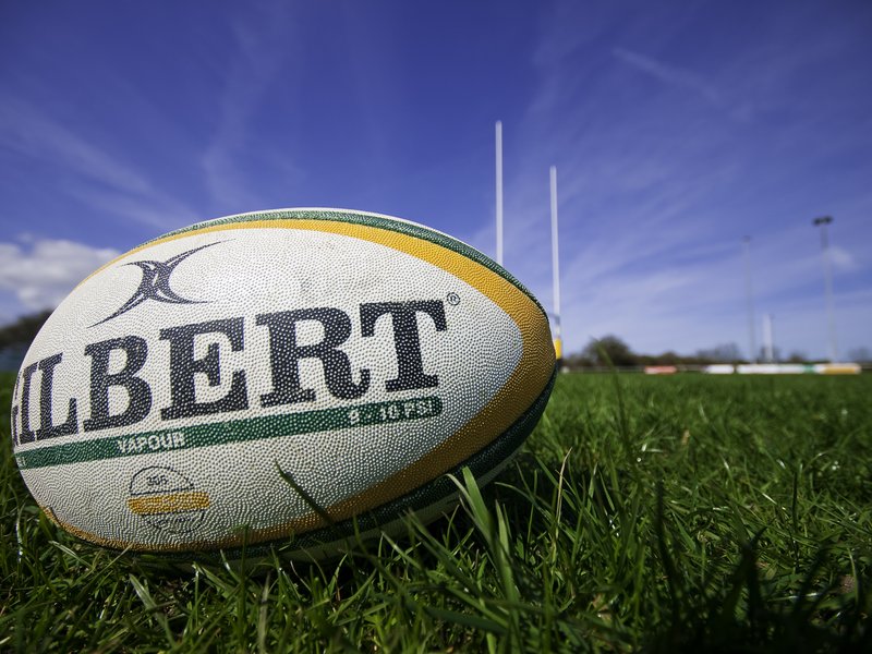 Suffolk, UK - April 11, 2010; A rugby ball manufactured by Gilbert rugby, laying on a rugby pitch