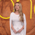 Syndey Sweeney wearing a white dress with a cape