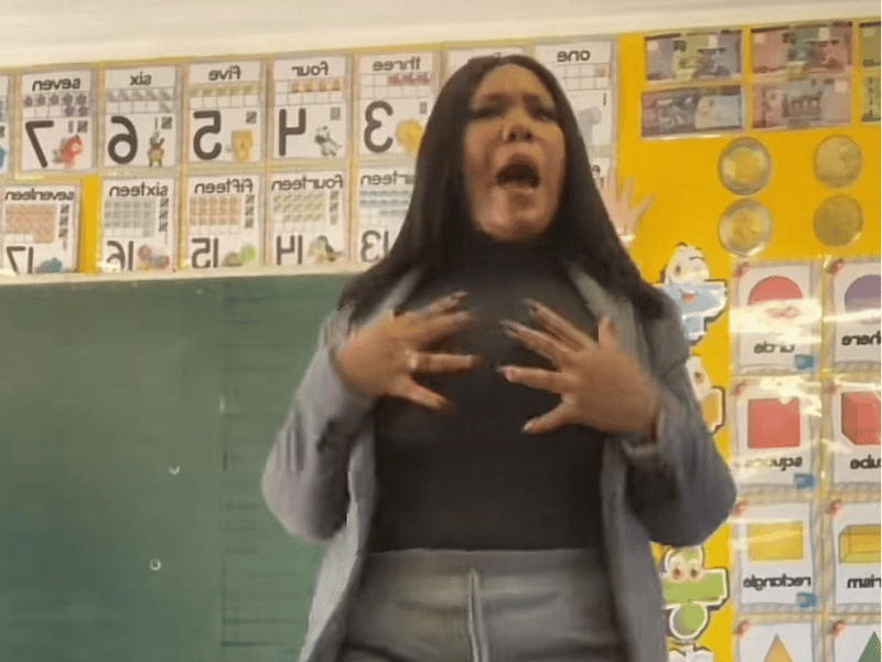 TEACHER SINGING IN FRONT OF CLASS