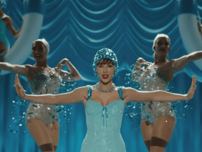 Taylor Swift wearing a turquoise one piece
