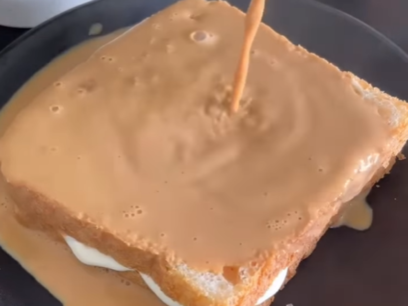 Tea being poured onto two slices of toast