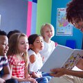 Teacher reading to young kids