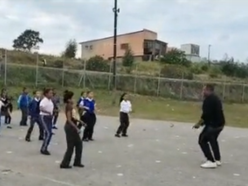 Teacher teaching his students how to dance