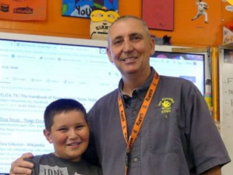 Teacher with arm around student in class