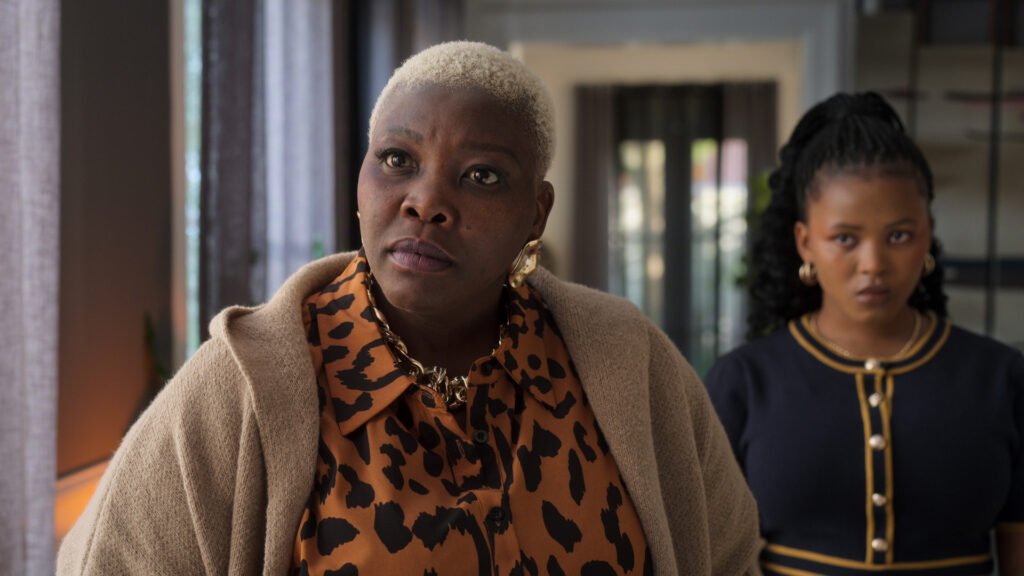 Celeste Ntuli as Essie Gomora, and Lwazi Keith Tsebesha as Sarah Gomora in The Polygamist | Cr. Courtesy of Netflix © 2026