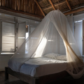 The interior of a cabin showing a bed with a mosquito net