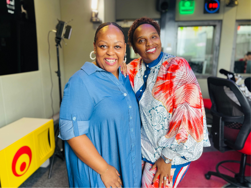 Thobekile Ndlovu and Carol Ofori stand inside the East Coast Radio studios