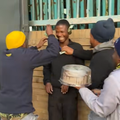 Three friends celebrate their friend with money and a birthday cake