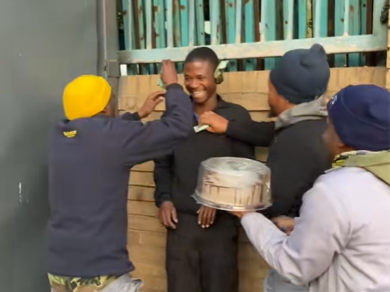 Three friends celebrate their friend with money and a birthday cake
