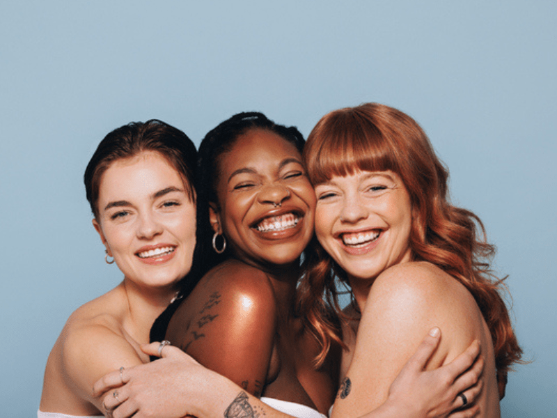Three women embracing each other