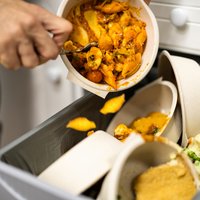 Throwing Away Leftover Food In Trash