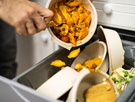 Throwing Away Leftover Food In Trash