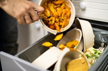 Throwing Away Leftover Food In Trash