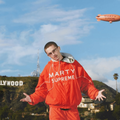 Timothée Chalamet wearing a bright orange Marty Supreme jacket
