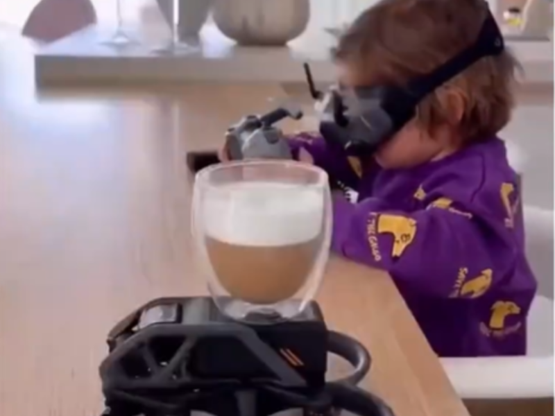 Toddler operating a drone with remote and VR gear