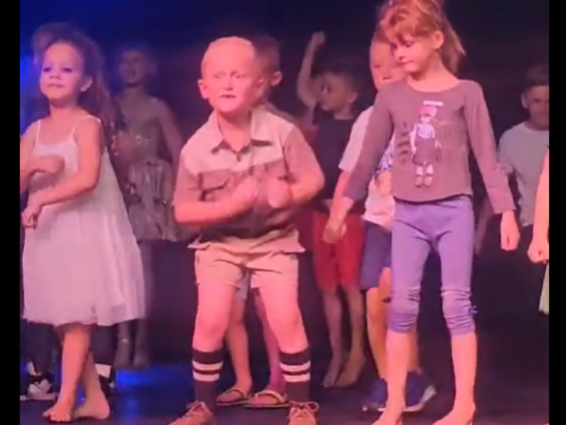 Toddlers dancing on stage for school concert