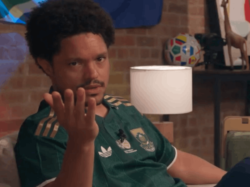 Trevor Noah wearing a green Bafana Bafana jersey